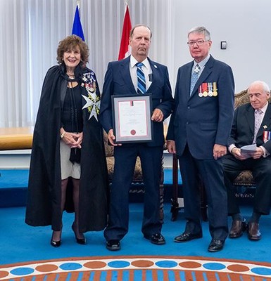 Arvid Thompson receives his Life-saving Award from Lt.-Gov. Lois E. Mitchell, at left, and John McDougall of St. John Ambulance.