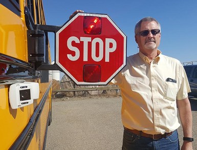 David Shaw, Palliser Regional Schools Transportation Services Supervisor, with one of the new buses outfitted with a video camera system.