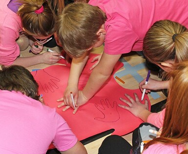 Noble Central School students decorate Pink Shirt Day T-shirt cut-outs.