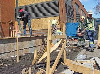 Milestone Construction crews work on the foundation of the four-classroom, two-storey addition at Heritage Christian Academy.