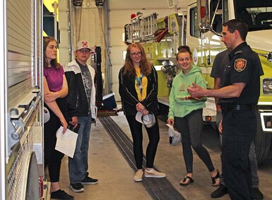 Coaldale Fire Chief Kevin McKeown shows students around the fire hall as part of an orientation for the Kate Andrews Fire Academy program.