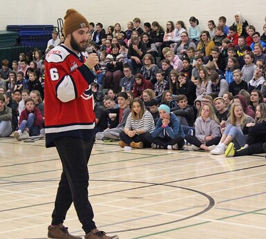 Defenceman Ty Prefontaine addresses students and staff at R.I. Baker Middle School in Coaldale during a presentation on concussions by Lethbridge Hurricanes hockey players and staff.