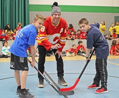 Former Calgary Flame Matt Stajan performs the ceremonial puck drop to kick off Calgary Christian School’s annual floor hockey tournament.