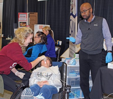 Nicole Elaschuk of Picture Butte High School, at left, gets a hands-on introduction to dentistry at the Exploring Possible Industries and Careers (EPIC) Day career fair.