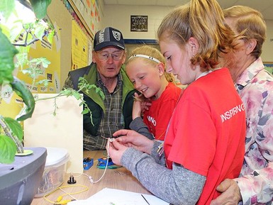 Students show off their classroom project to visitors during Leadership Day.