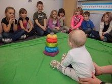 Grade 1 students at Noble Central School get acquainted with baby Maggie during the Roots of Empathy program.