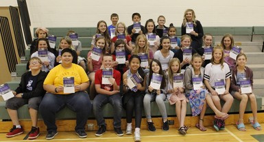 Teacher McKenna Golding and her students hold a copy of their new book "A Jumble of Words."